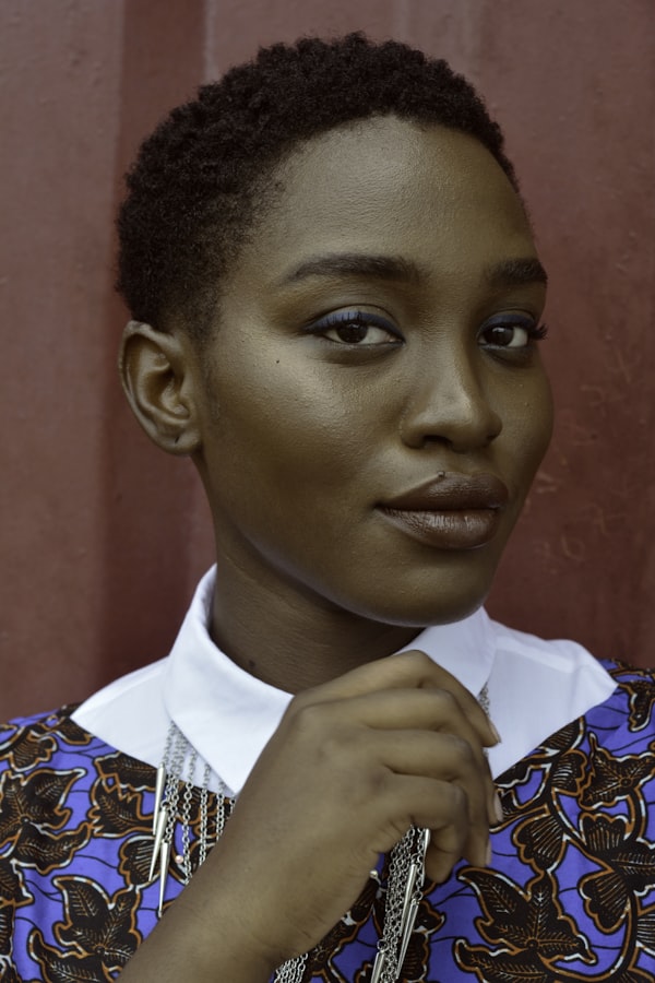 Woman with short hair and a patterned top, head-and-shoulders portrait