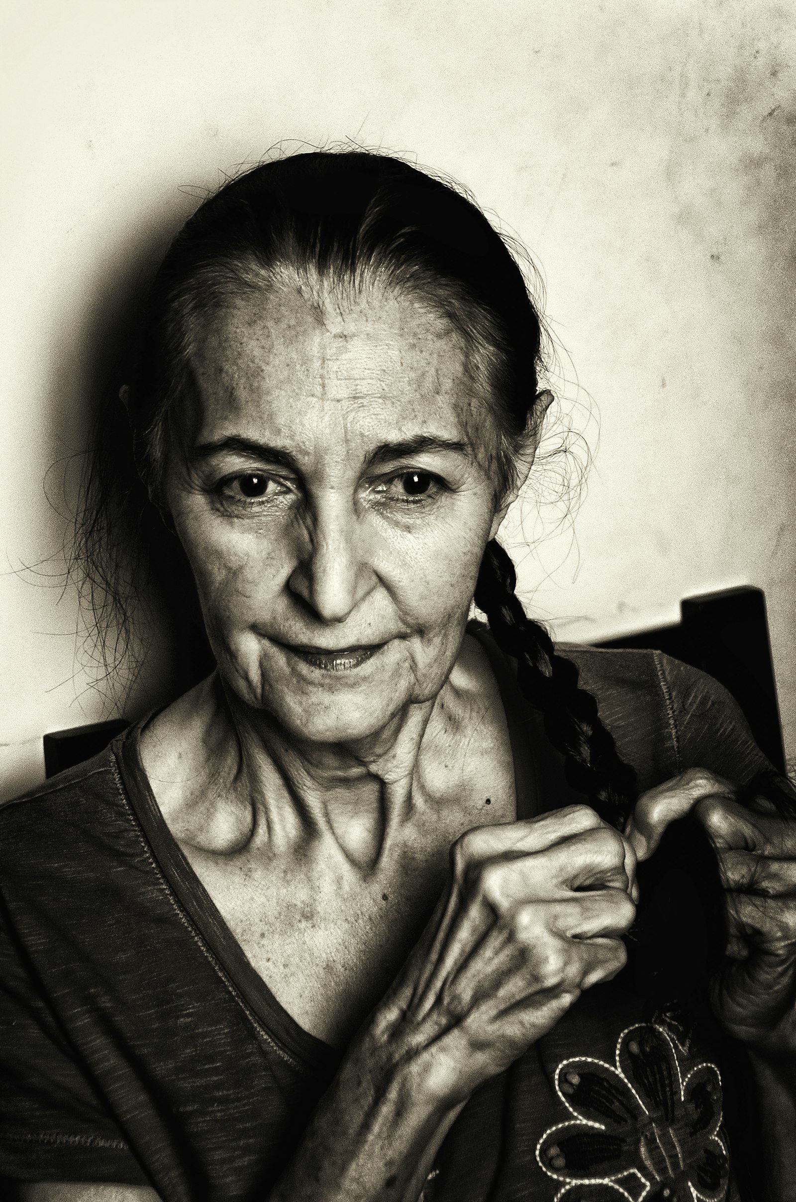 Grayscale portrait of a woman with braided hair
