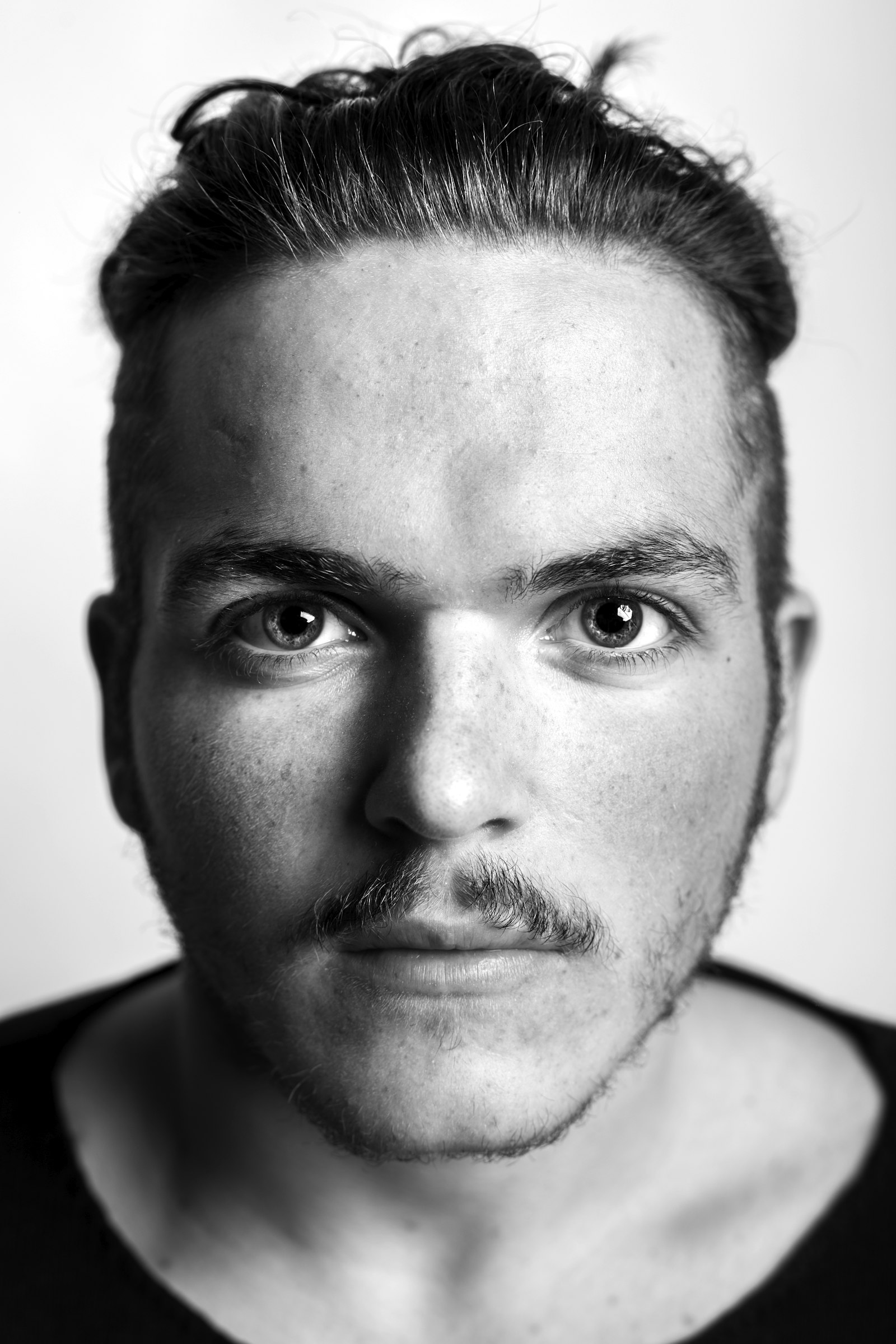 Grayscale portrait of a man in a plain top