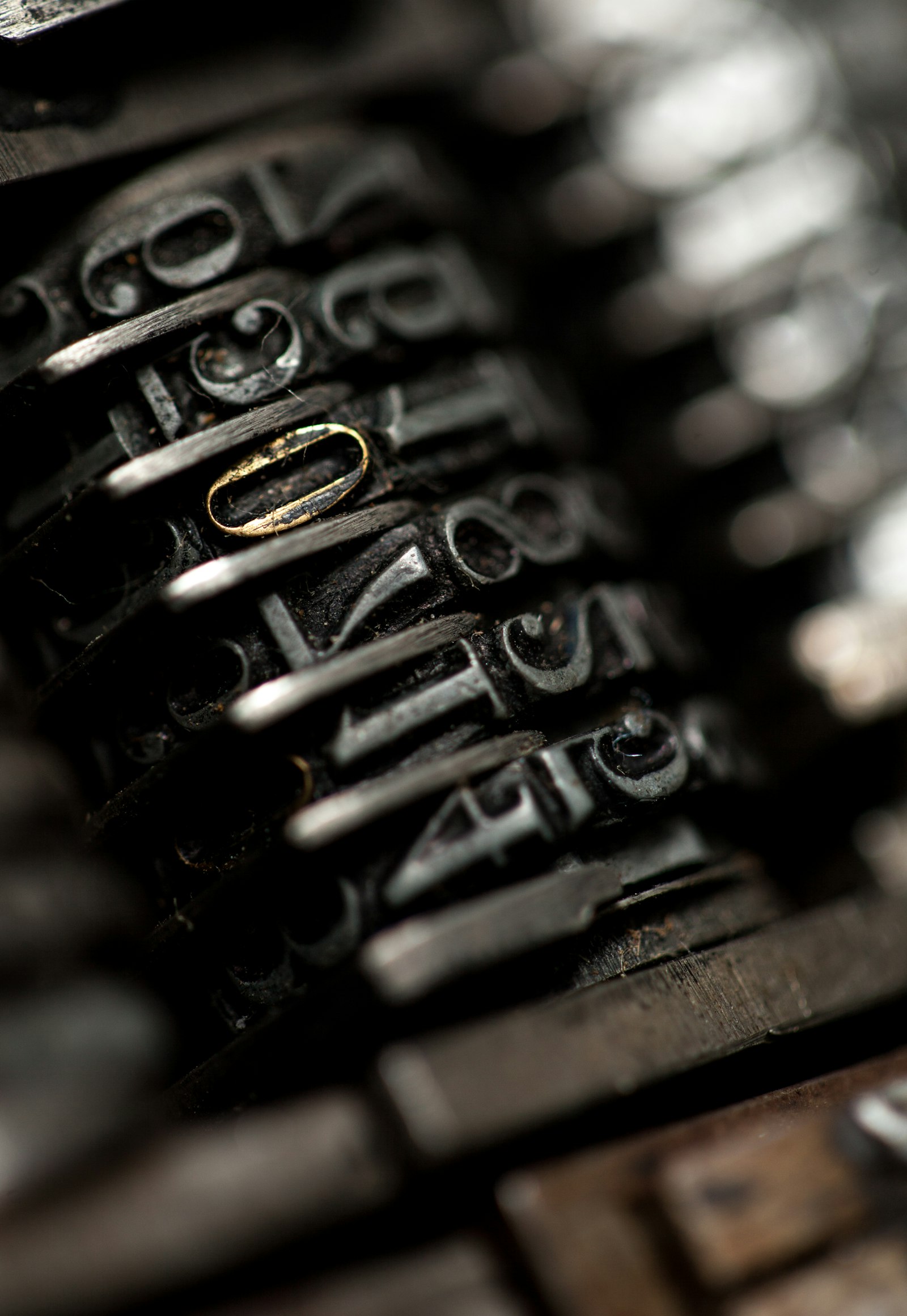 Close-up of worn metal characters on an old machine