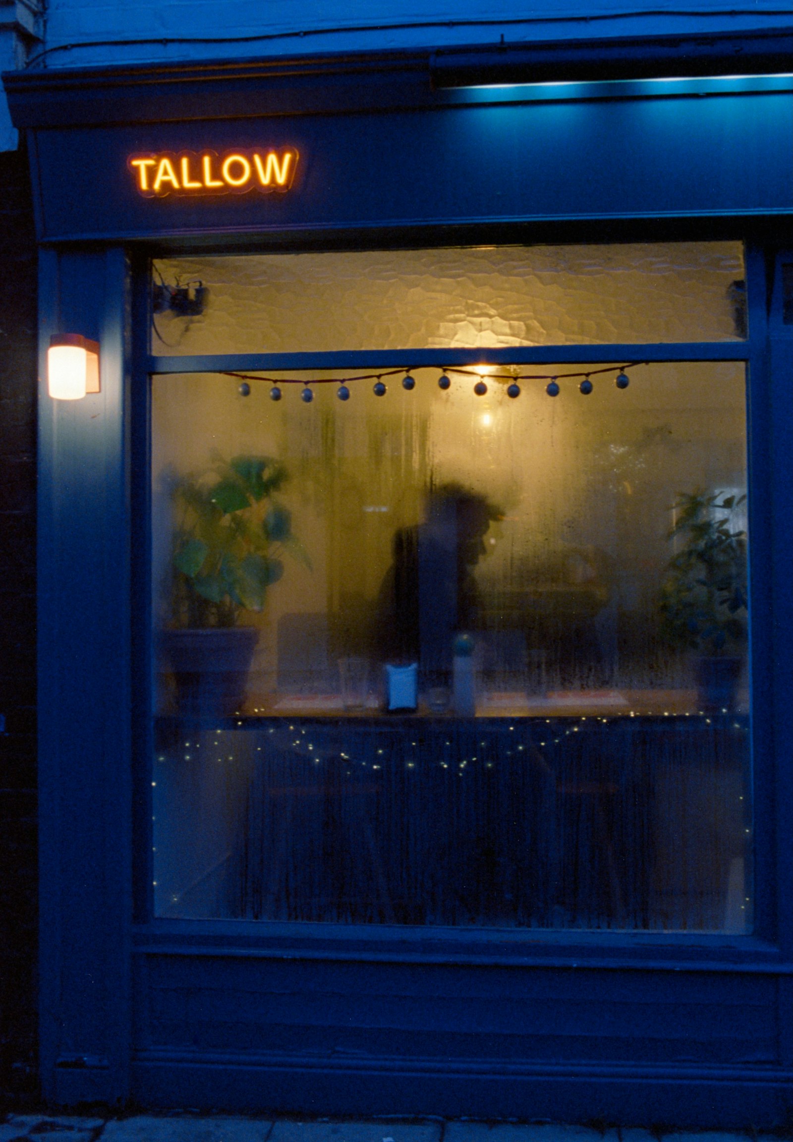 Storefront with a neon sign and warm interior light