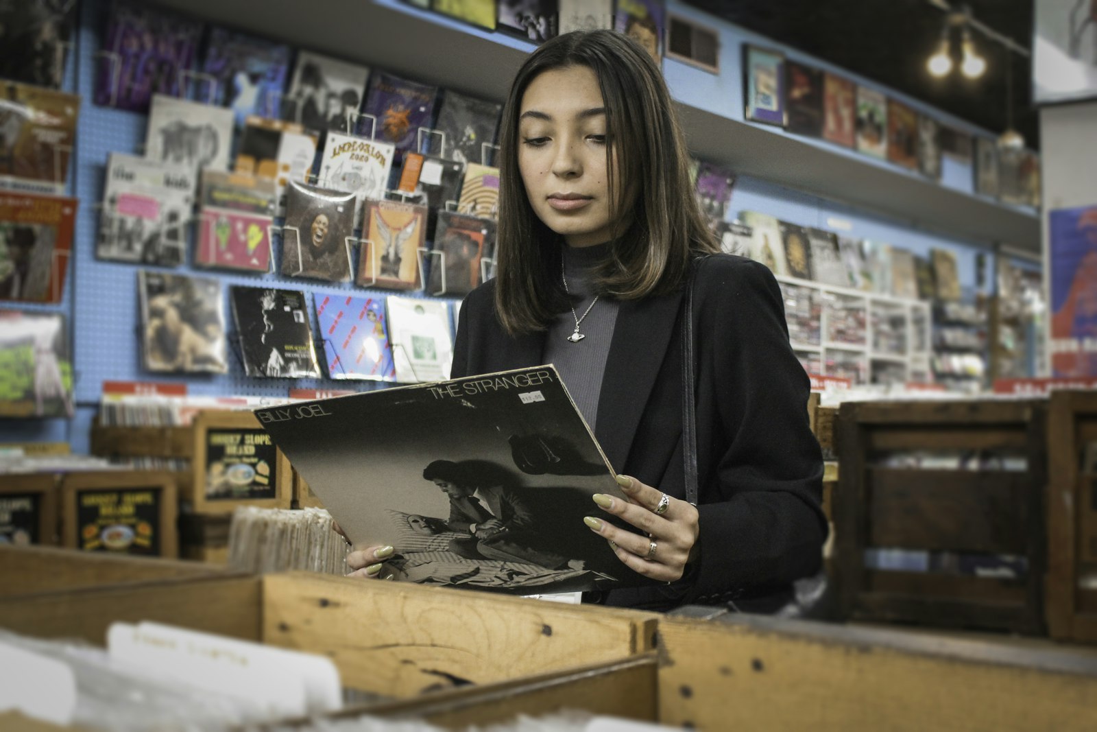 Woman looking at a record sleeve in a record shop