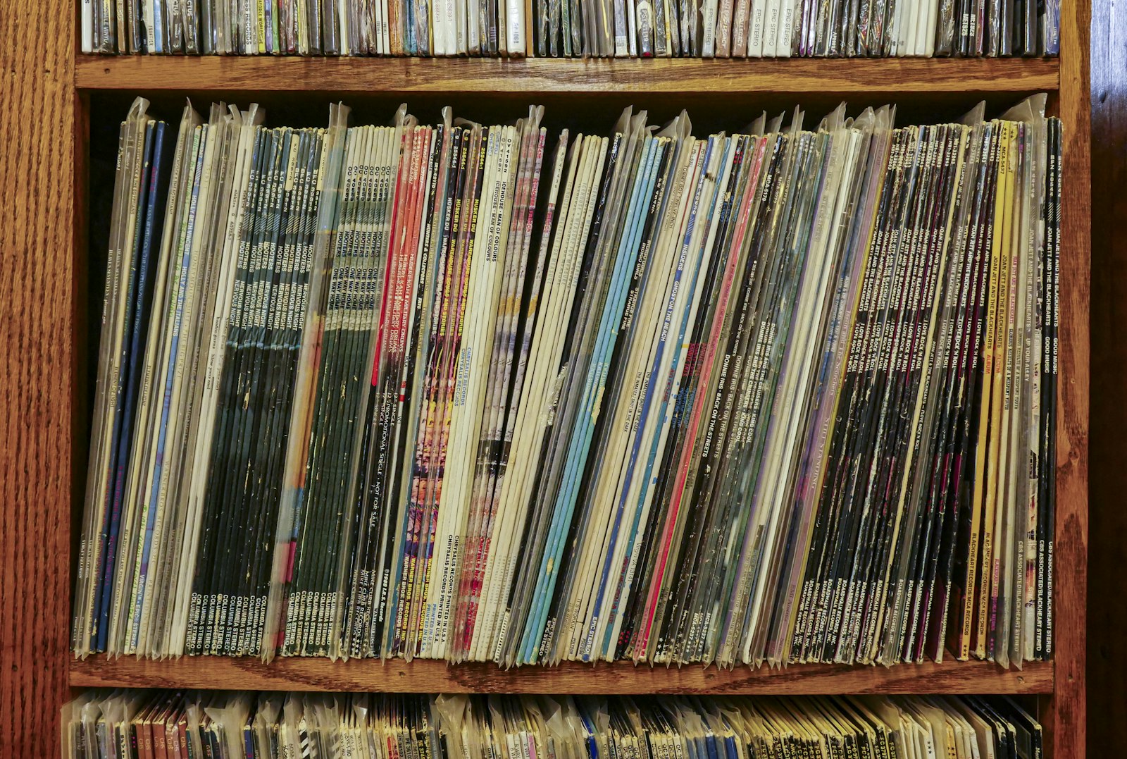 Shelf packed with LPs in printed sleeves