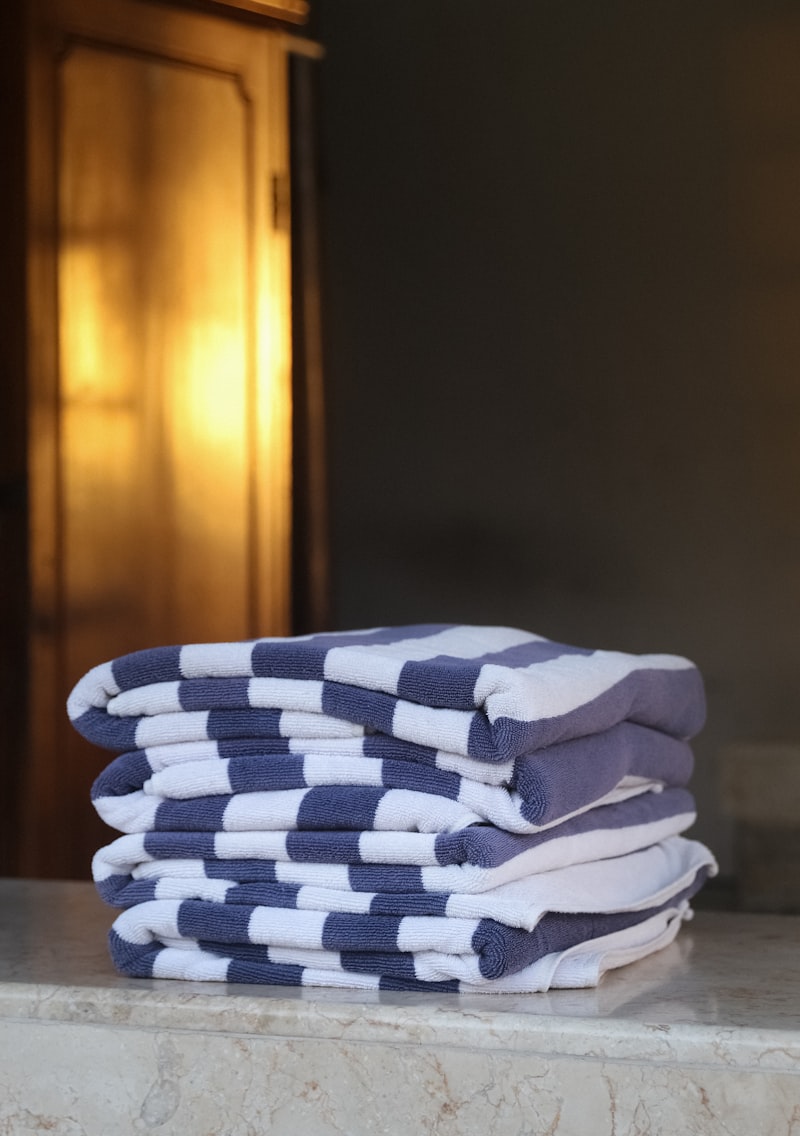 Stack of fresh towels by warm lamp light