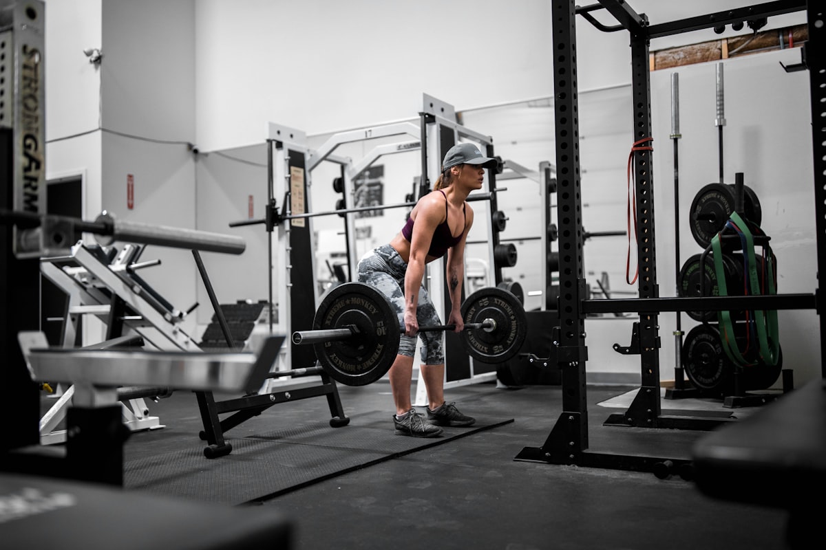 Lifter setting up a heavy pull inside the power rack
