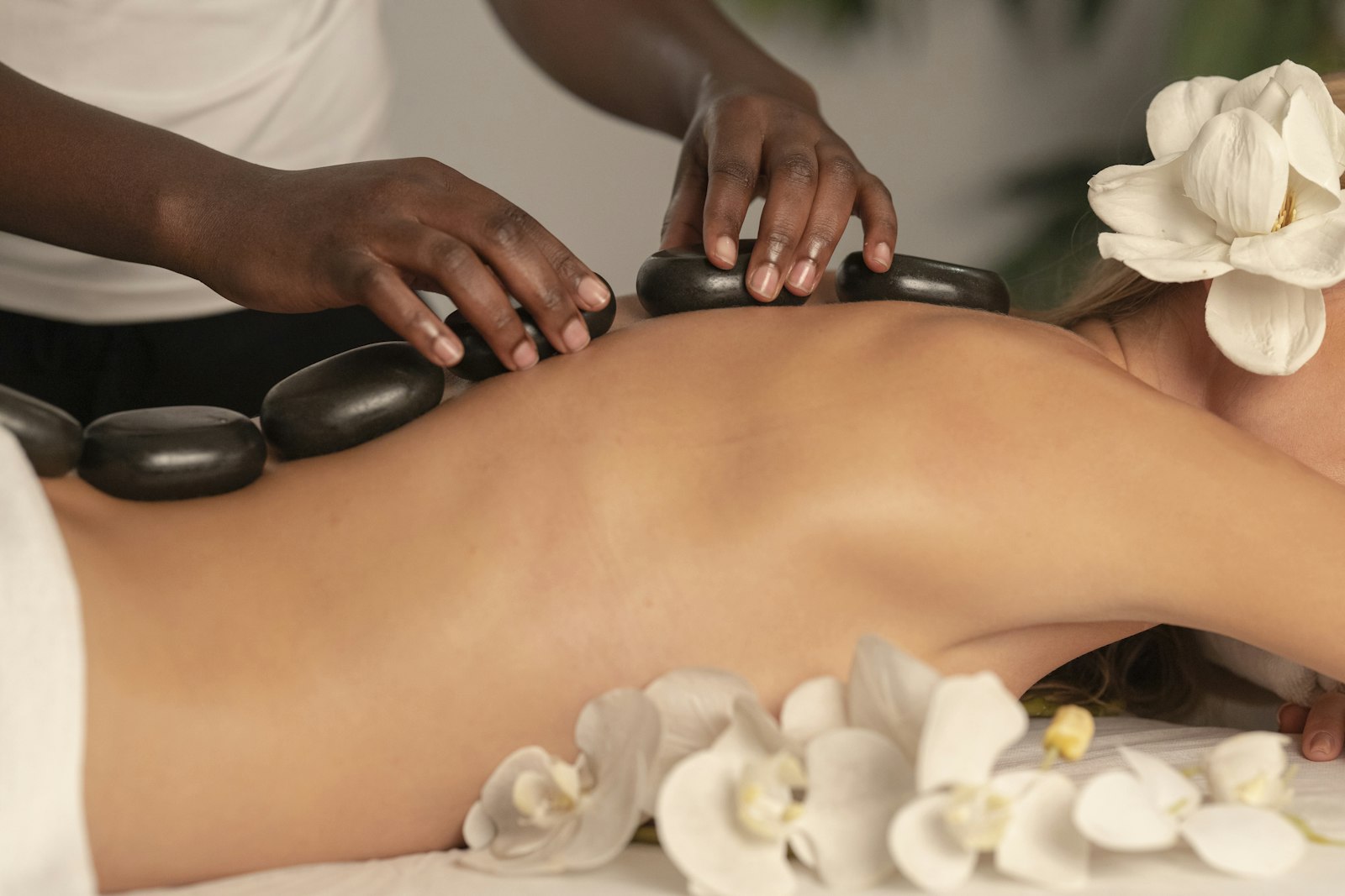 Hot-stone massage in warm neutral tones