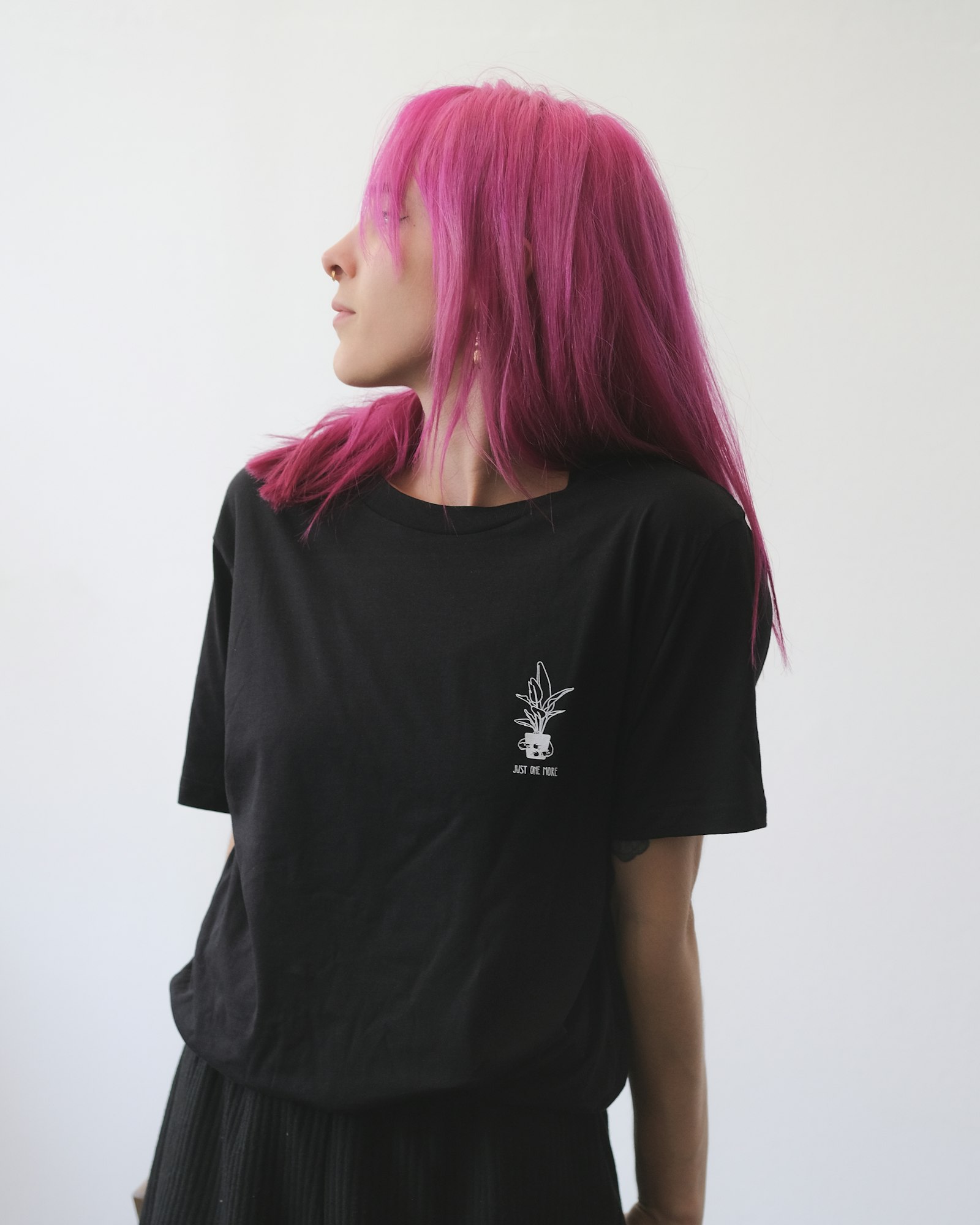 Client with vivid pink hair photographed in a color studio
