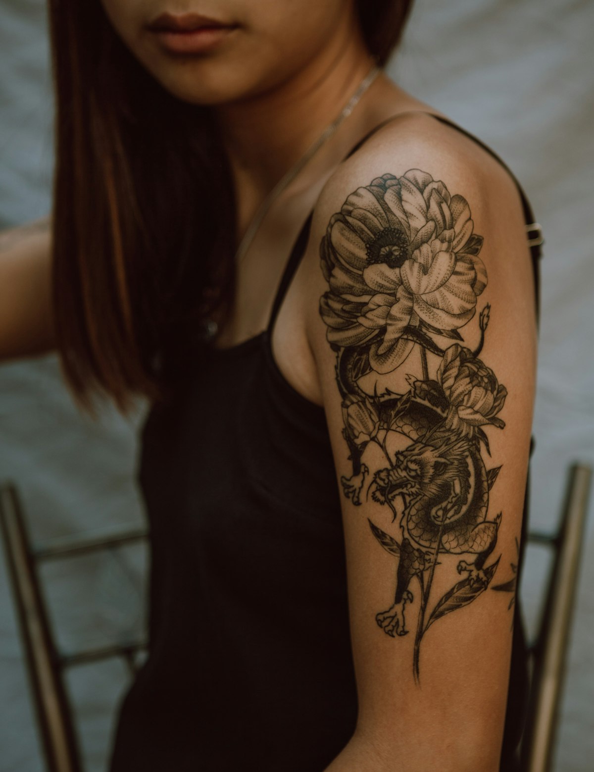 Fine-line tattoo across a shoulder